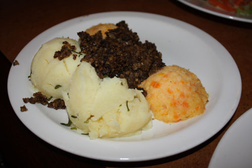 Having Haggis, a traditional dish of Scotland out of sheeps entrails